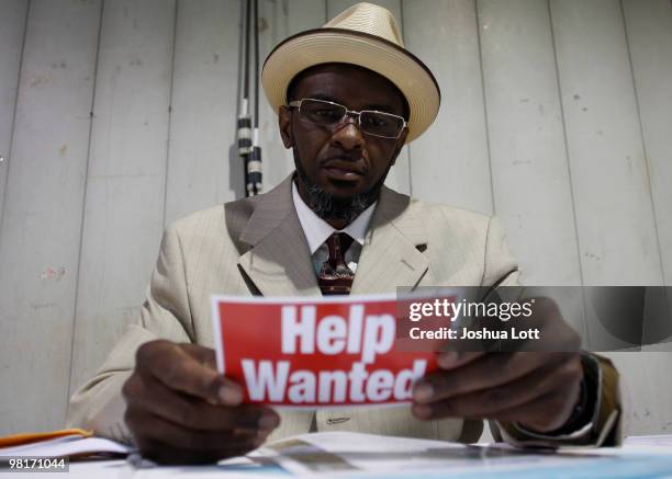 Khalifah Varnado reads a help wanted post card during the Arizona Workforce Connection Career Expo at the Arizona State Fair Grounds on March 31,...