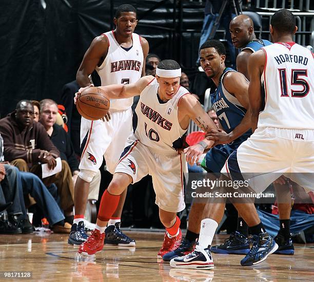 Mike Bibby of the Atlanta Hawks moves the ball against Ramon Sessions of the Minnesota Timberwolves during the game on February 24, 2010 at Philips...
