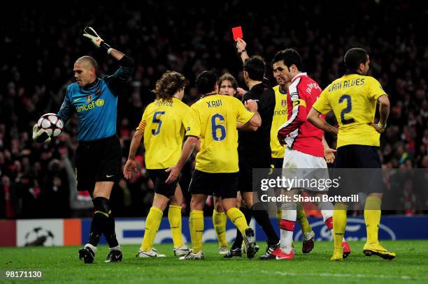 Goalkeeper Victor Valdes of Barcelona reacts as team mate Carles Puyol is shown a red card by referee Massimo Busacca of Switerland after bringing...