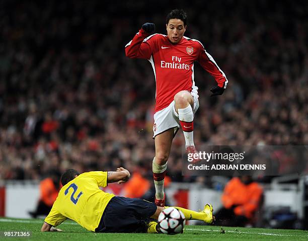 Arsenal's French midfielder Samir Nasri vies with Barcelona's Brazilian defender Daniel Alves during their UEFA Champions League quarter-final 1st...