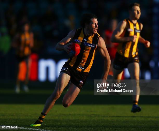 Isaac Smith of the Hawks runs with the ball during the round 14 AFL match between the Hawthorn Hawks and the Gold Coast Suns at University of...