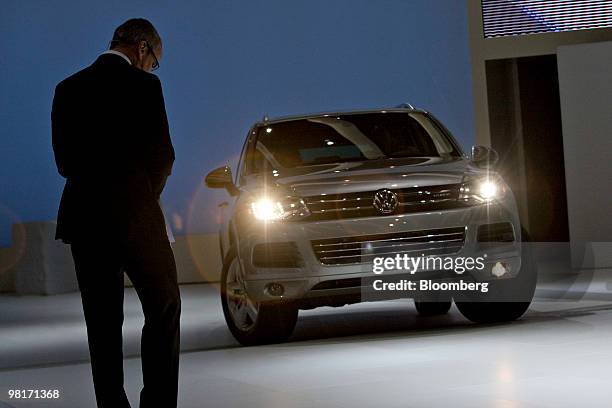 Stefan Jacoby, president and chief and chief executive officer of Volkswagen AG's North America unit, looks on as a Volkswagen Touareg Hybrid is...