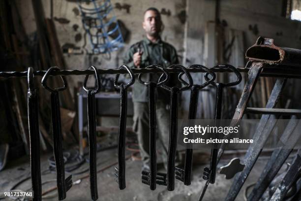 Dpatop - Palestinian blacksmith Ali Banat makes "Keys of Return", which symbolize the right of Palestinian refugees to return to homes they were...