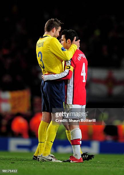 Former team mates Gerard Pique of Barcelona and Cesc Fabregas of Arsenal hug each other following their teams' 2-2 draw in the UEFA Champions League...