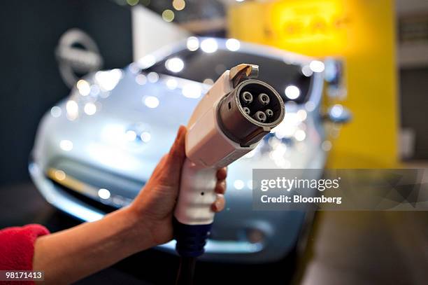 The charger for a Nissan Leaf electric vehicle is displayed for a photograph during a media preview of the New York International Auto Show in New...