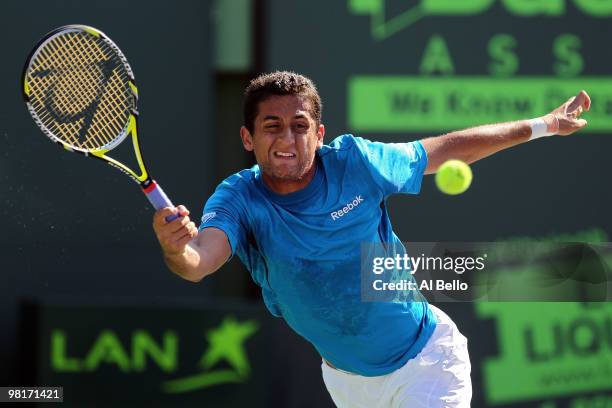 Nicolas Almagro of Spain returns a shot against Andy Roddick of the United States during day nine of the 2010 Sony Ericsson Open at Crandon Park...