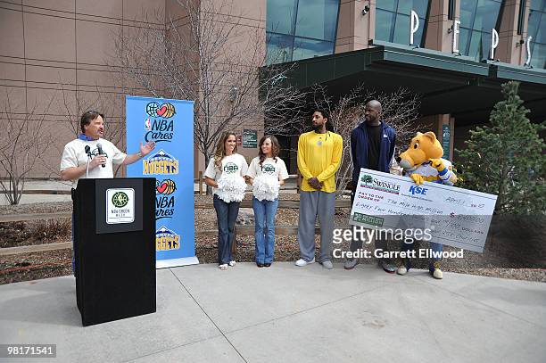 Tom Tolkacz from Swingle Tree and Lawn Care, members of the Denver Nuggets Dance Team, Renaldo Balkman, Johan Petro and SuperMascot Rocky kick-off...