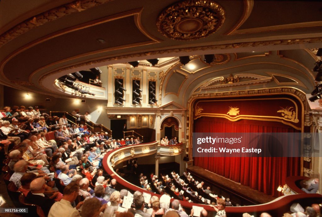 Interior of theatre, audience waiting for performance to start