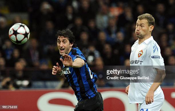 Diego Milito of Inter Milan and Vasili Berezutski of CSKA Moscow compete for the ball during the UEFA Champions League Quarter Finals, First Leg...