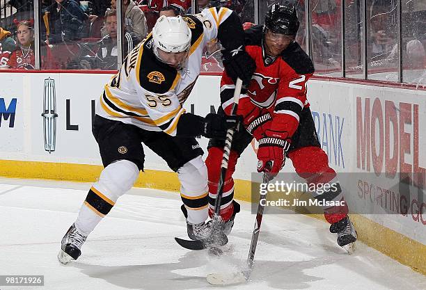 Johnny Boychuk of the Boston Bruins skates against Bryce Salvador of the New Jersey Devils at the Prudential Center on March 30, 2010 in Newark, New...