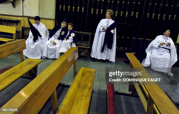 Penitents wait before taking part in the ''Nuestro Padre Jesus de la Salud" brotherhood procession during the Holy Week in Madrid on March 31, 2010....