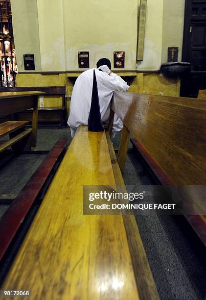 Penitent waits before taking part in the ''Nuestro Padre Jesus de la Salud" brotherhood procession during the Holy Week in Madrid on March 31, 2010....