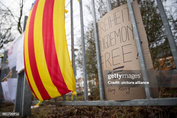 April 2018, Germany, Neumuenster: A protest sign reading 'Freiheit Puigdemont Free! Catalans from Hong Kong' and the estelada, the flag of Catalan...