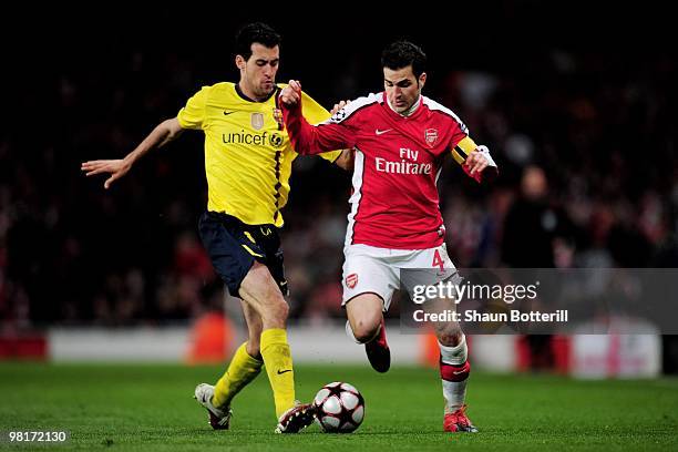 Cesc Fabregas of Arsenal is tackled by Sergio Busquets of Barcelona during the UEFA Champions League quarter final first leg match between Arsenal...