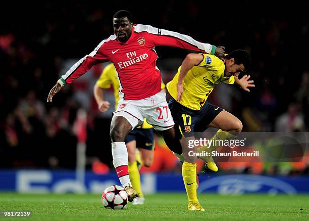 Emmanuel Eboue of Arsenal is challenged by Pedro Rodriguez of Barcelona during the UEFA Champions League quarter final first leg match between...