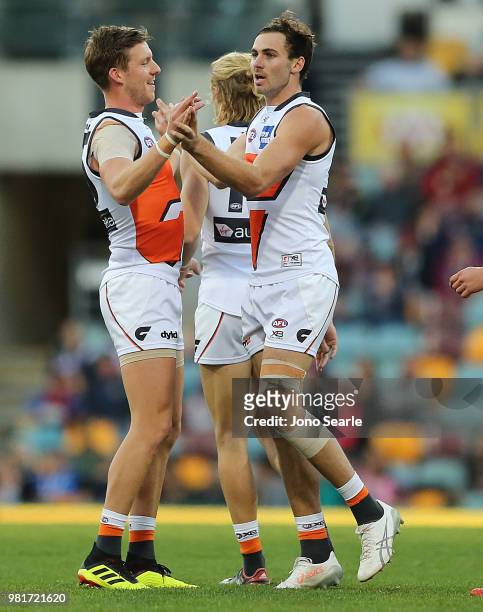 Aidan Corr of the Giants celebrates a goal with Jeremy Finlayson of the Giants during the round 14 AFL match between the Brisbane Lions and the...