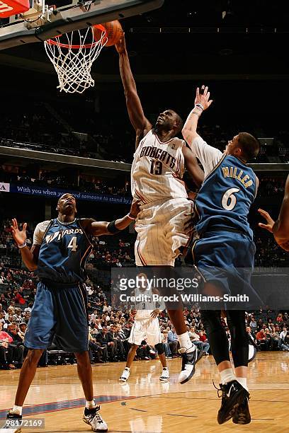 Nazr Mohammed of the Charlotte Bobcats lays up a shot against Antawn Jamison and Mike Miller of the Washington Wizards during the game on February 9,...
