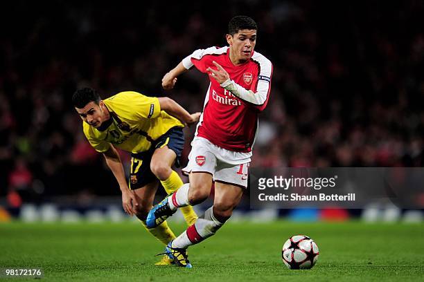 Denilson of Arsenal goes past Pedro Rodriguez of Barcelona during the UEFA Champions League quarter final first leg match between Arsenal and FC...