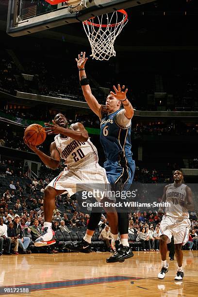 Raymond Felton of the Charlotte Bobcats takes the ball to the basket against Mike Miller of the Washington Wizards during the game on February 9,...