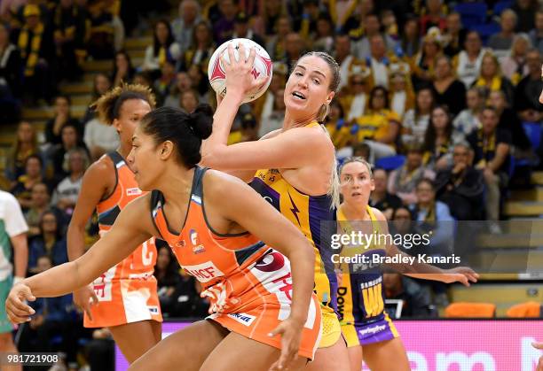 Caitlin Bassett of the Lightning takes on the defence during the round eight Super Netball match between the Lightning and the Giants at University...