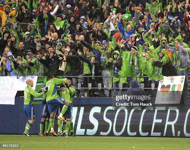 Players of the Seattle Sounders FC celebrate a goal against the Philadelphia Union at Qwest Field on March 25, 2010 in Seattle, Washington. The...