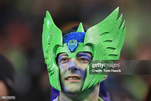 Costumed male fan of the Seattle Sounders FC watches the play during the game against the Philadelphia Union at Qwest Field on March 25, 2010 in...