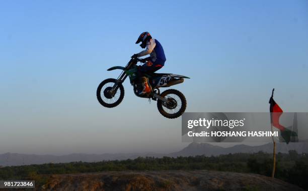 In this photograph taken on June 22, 2018 an Afghan rider takes part in a freestyle motocross event in the western city of Herat.