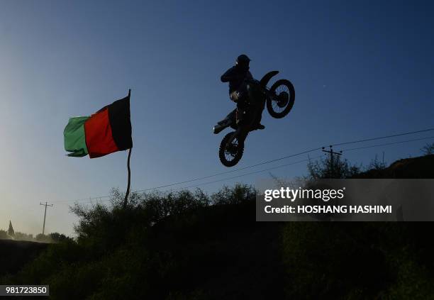 In this photograph taken on June 22, 2018 an Afghan rider takes part in a freestyle motocross event in the western city of Herat.