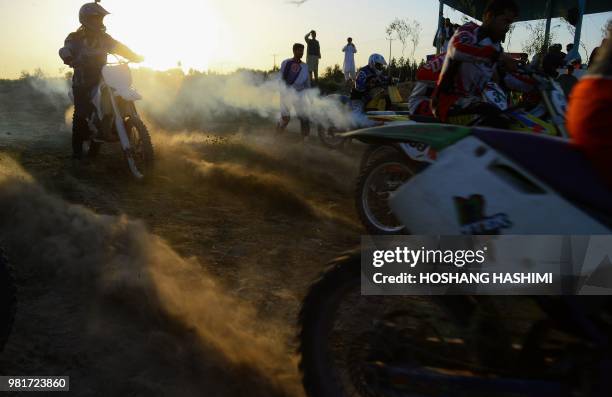 In this photograph taken on June 22, 2018 Afghan riders take part in a freestyle motocross event in the western city of Herat.