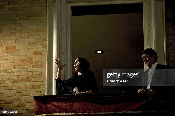 Spanish singer Diana Navarro performs a "saeta" cheered by Spanish actor Antonio Banderas during the "Fusionadas" brotherhood procession as part of...