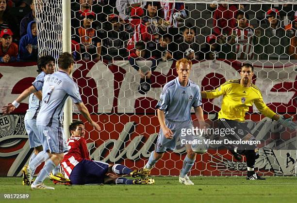 Goalkeeper Matt Pickens and Jeff Larentowicz of the Colorado Rapids defend their net as Sacha Kljestan of Chivas USA looks on in the first half of...