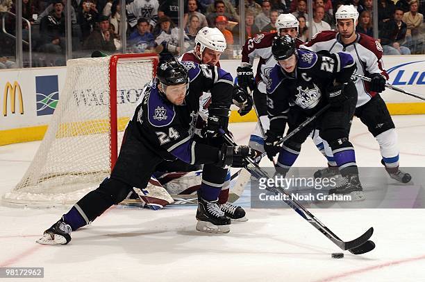 Alexander Frolov of the Los Angeles Kings reaches for the puck against the Colorado Avalanche on March 22, 2010 at Staples Center in Los Angeles,...