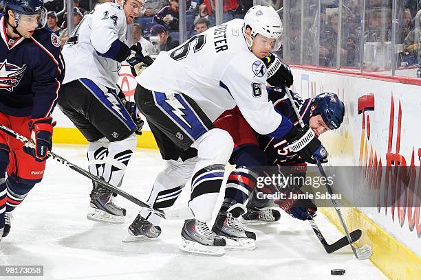 Defenseman Kurtis Foster of the Tampa Bay Lightening defends against forward Derek Dorsett of the Columbus Blue Jackets on March 30, 2010 at...