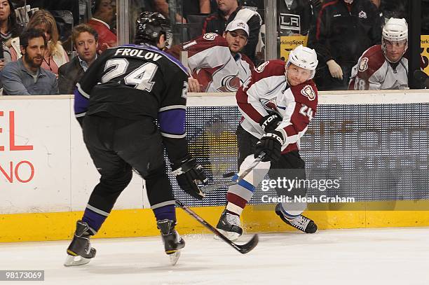 Ruslan Salei of the Colorado Avalanche passes the puck against Alexander Frolov of the Los Angeles Kings on March 22, 2010 at Staples Center in Los...