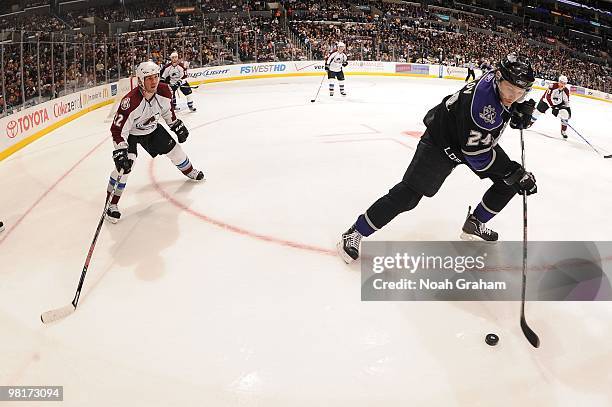 Alexander Frolov of the Los Angeles Kings skates with the puck against Scott Hannan of the Colorado Avalanche on March 22, 2010 at Staples Center in...