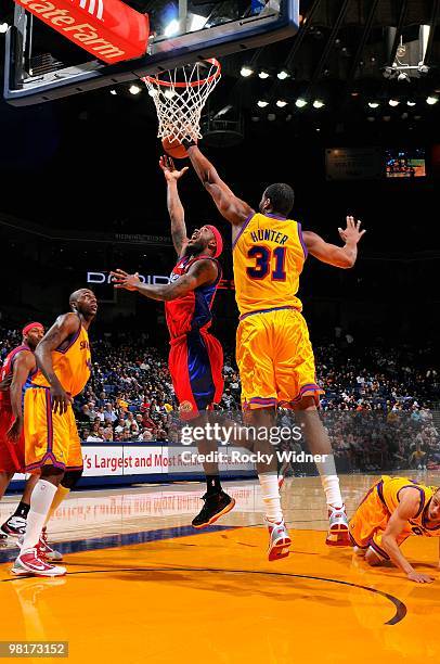 Bobby Brown of the Los Angeles Clippers lays the ball up over Chris Hunter of the Golden State Warriors during the game on February 10, 2009 at...