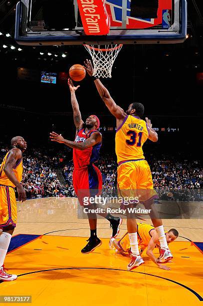 Bobby Brown of the Los Angeles Clippers puts a shot up over Chris Hunter of the Golden State Warriors during the game on February 10, 2009 at Oracle...