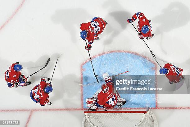 Jaroslav Halak of Montreal Canadiens warms up with teammate Travis Moen and Sergei Kostitsyn prior to the NHL game against the Carolina Hurricanes on...