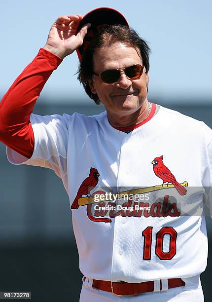 Manager Tony La Russa of the St Louis Cardinals salutes fans before taking on the Washington Nationals at Roger Dean Stadium on March 31, 2010 in...