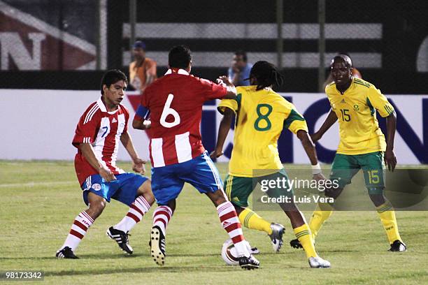 South Africa's Thwala looks on as Rodolfo Gamarra and Carlos Bonet of Paraguay fight for the ball in an international friendly match between Paraguay...