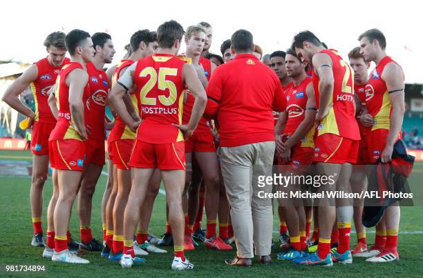 Stuart Dew, Senior Coach of the Suns speaks with his players after the 2018 AFL round 14 match between the Hawthorn Hawks and the Gold Coast Suns at...
