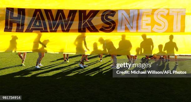 The Hawks prepare to run through their banner during the 2018 AFL round 14 match between the Hawthorn Hawks and the Gold Coast Suns at UTAS Stadium...