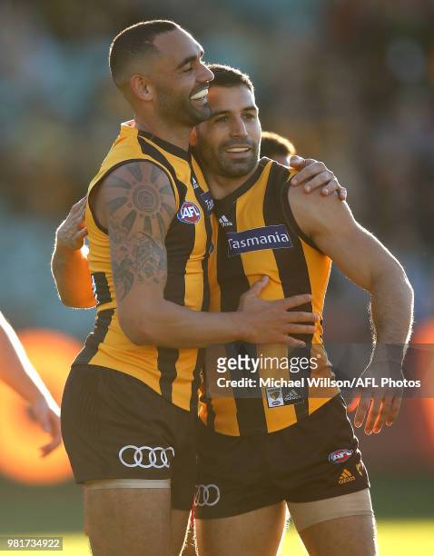 Shaun Burgoyne and Paul Puopolo of the Hawks celebrate during the 2018 AFL round 14 match between the Hawthorn Hawks and the Gold Coast Suns at UTAS...
