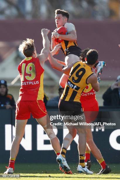 Taylor Duryea of the Hawks takes a spectacular mark over Charlie Ballard of the Suns during the 2018 AFL round 14 match between the Hawthorn Hawks...