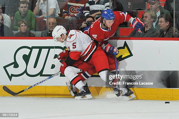 Brian Pothier of the Carolina Hurricanes collides with Sergei Kostitsyn of Montreal Canadiens during the NHL game on March 31, 2010 at the Bell...