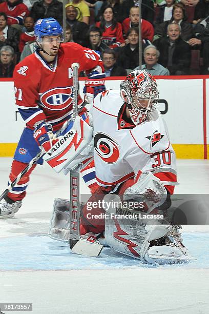 Cam Ward of the Carolina Hurricanes and Brian Gionta of Montreal Canadiens looks at the goal of his teammate Marc-Andre Bergeron during the NHL game...