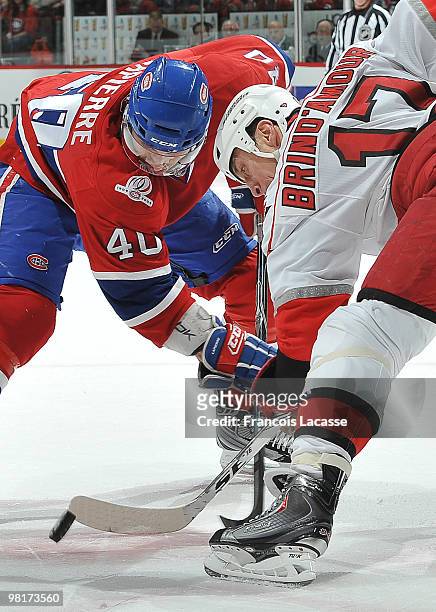 Maxim Lapierre of Montreal Canadiens and Rod Brind'Amour of the Carolina Hurricanes face off during the NHL game on March 31, 2010 at the Bell Center...