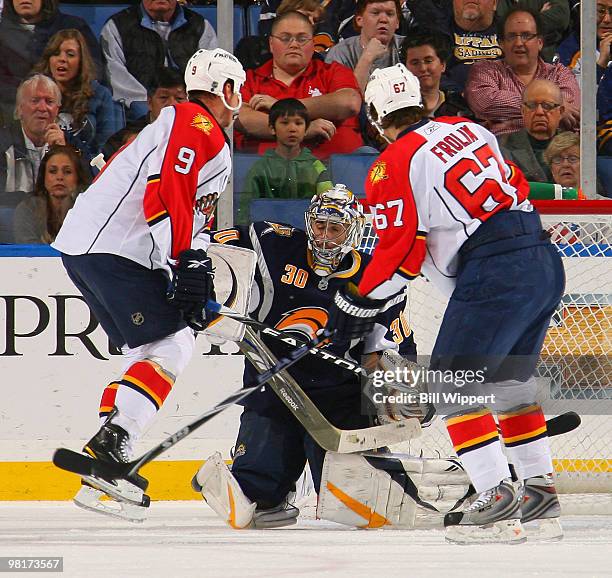 Ryan Miller of the Buffalo Sabres makes a first-period save between Stephen Weiss and Michael Frolik of the Florida Panthers on March 31, 2010 at...