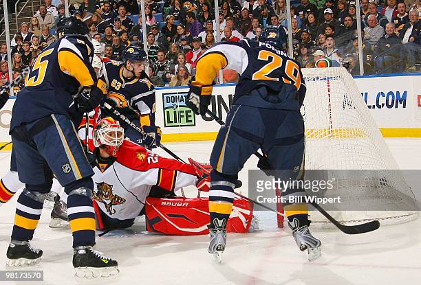 Jason Pominville of the Buffalo Sabres scores his first-period goal by banking the puck off the skate of goaltender Tomas Vokoun of the Florida...