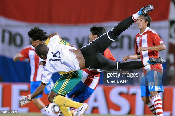 South African goalie Itumeleng Khune and player Siyabonga Sangweni vie for the ball with Paraguayan Rodrigo Rojas during their friendly match in...